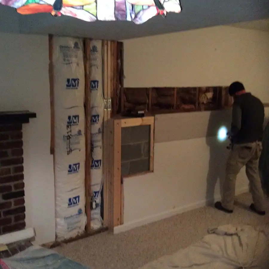 Restoration technician inspecting water damage in Shaker Heights